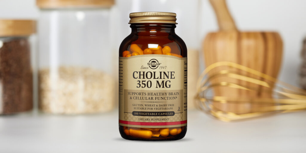 A bottle of Solgar Choline 350mg capsules in a clean white kitchen.