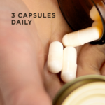 Three white capsule of Solgar Muscle Maintenance, being poured from an amber glass bottle into a hand. Text on the image reads, "Three capsules daily"