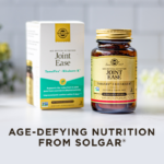 A box and amber glass bottle of Solgar Joint Ease supplement, on a clean white kitchen background. Text on image reads, "Age-defying nutrition from Solgar".