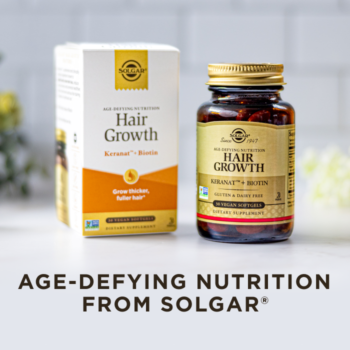 A box and amber glass bottle of Solgar Hair Growth supplement, on a clean white kitchen background. Text on image reads, "Age-defying nutrition from Solgar".