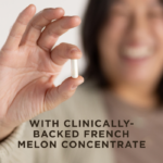 A woman smiling holding one white capsule of Solgar Cellulite Fighter in her fingertips. Text on image reads, "With clinically-backed French Melon Concentrate"