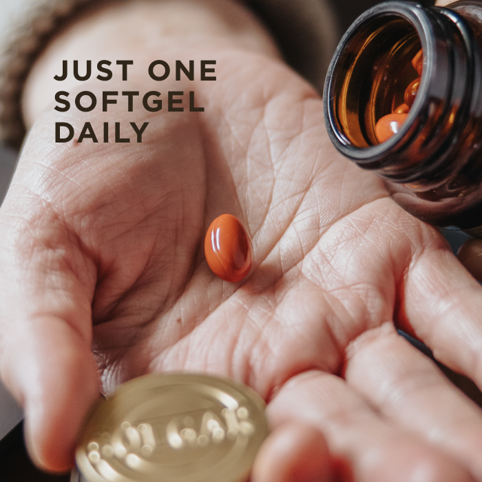 One red softgel capsule of Solgar Digital Defense, being poured from an amber glass bottle into a hand. Text on the image reads, "Just one softgel daily"